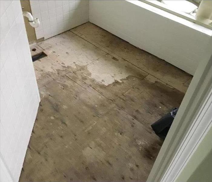 white room with water damaged floor