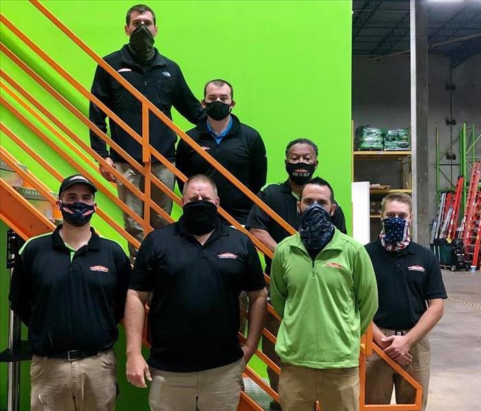 male SERVPRO production managers on steps wearing masks 