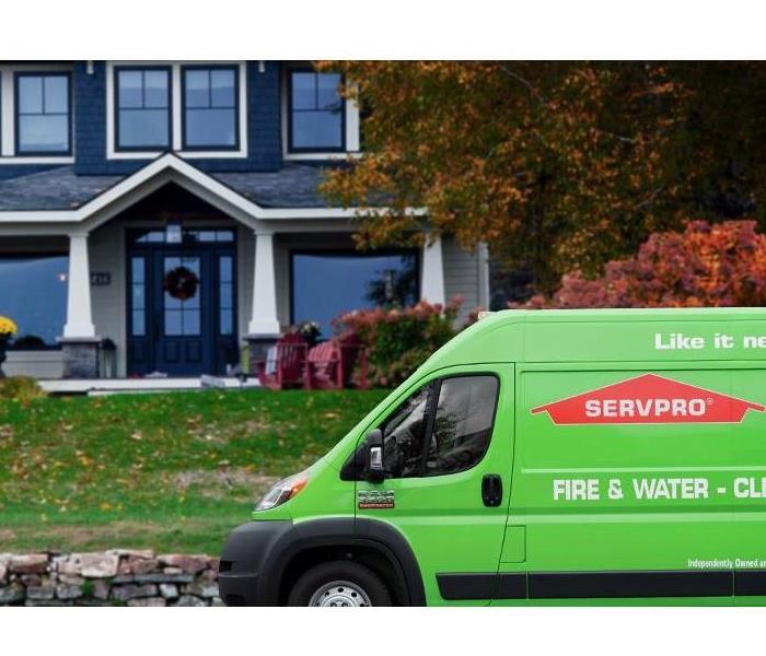 A SERVPRO van parked outside of a home