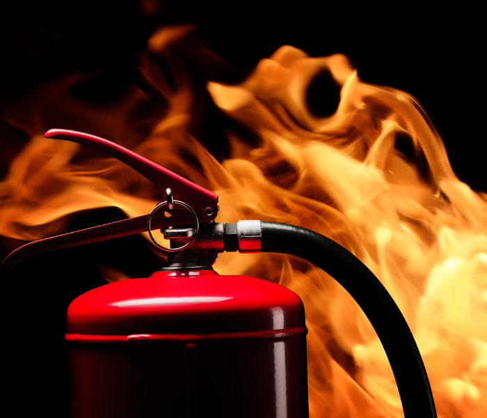 flame background with red fire extinguisher
