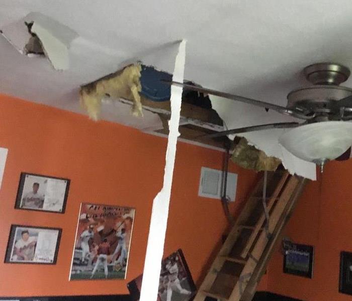 child's bedroom with ceiling damage from attic fire